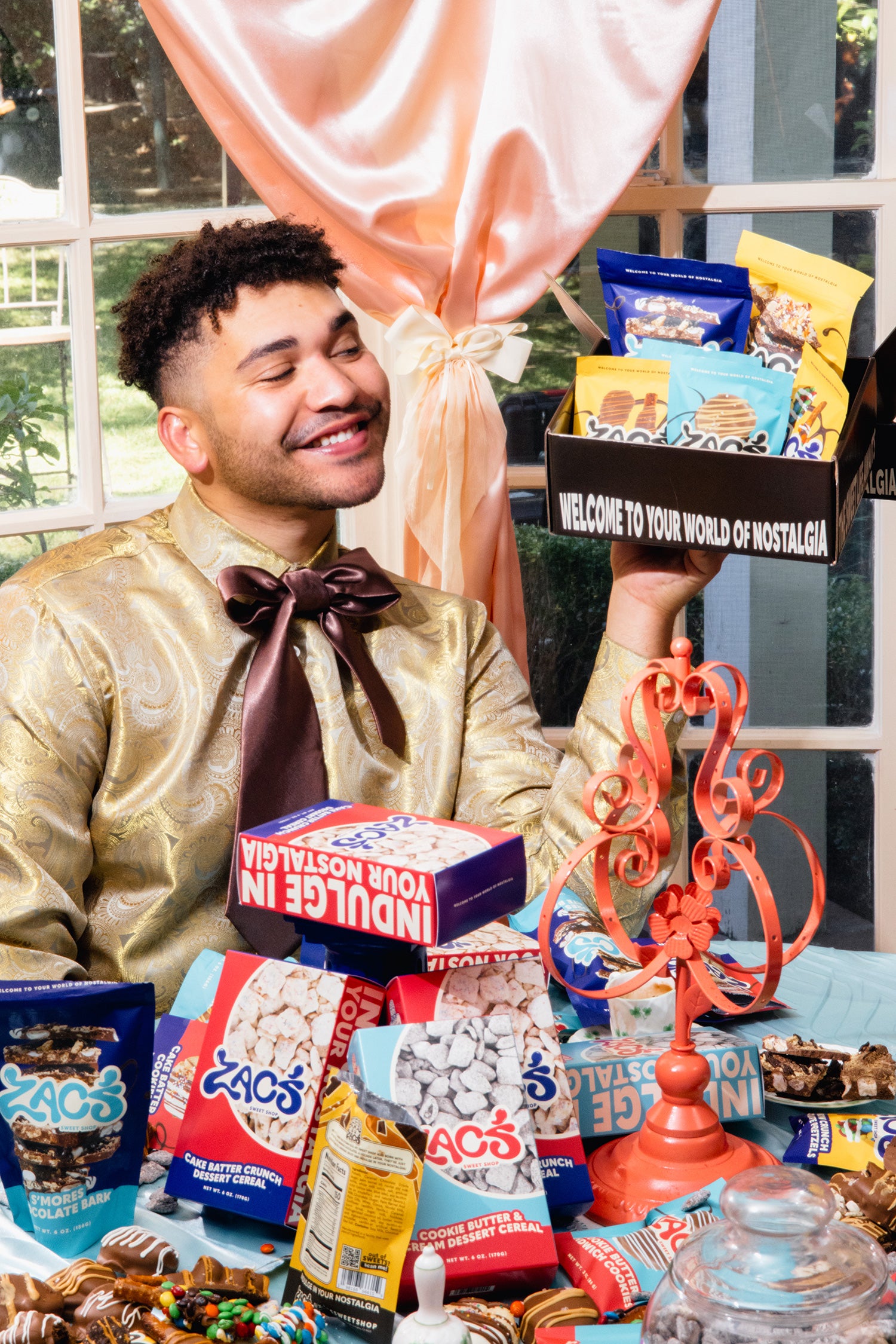 Zac holding an assortment of products